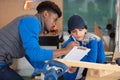 confident female carpenter measuring in workshop Royalty Free Stock Photo