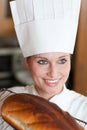 Confident female chef baking bread Royalty Free Stock Photo