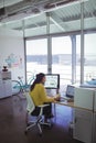 Confident female designer using digitizer on desk in office Royalty Free Stock Photo