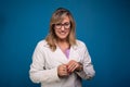 Confident female doctor dressed in beige coat, wearing glasses and smiling. Positive person Royalty Free Stock Photo