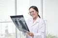 Confident female doctor examining accurately a rib cage x-ray Royalty Free Stock Photo