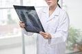 Confident female doctor examining accurately a rib cage x-ray Royalty Free Stock Photo