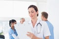 Confident female doctor holding clipboard Royalty Free Stock Photo