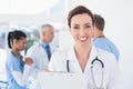 Confident female doctor holding clipboard Royalty Free Stock Photo