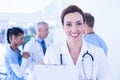 Confident female doctor holding clipboard Royalty Free Stock Photo