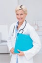 Confident female doctor holding file Royalty Free Stock Photo