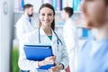 Confident female doctor holding medical records Royalty Free Stock Photo