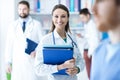 Confident female doctor holding medical records Royalty Free Stock Photo