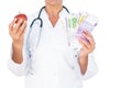 Confident female doctor holding red apple and banknotes Royalty Free Stock Photo