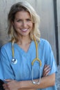 Confident female doctor posing in her office and smiling at camera, health care and prevention concept Royalty Free Stock Photo