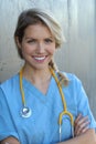 Confident female doctor posing in her office and smiling at camera, health care and prevention concept Royalty Free Stock Photo