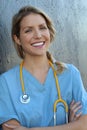 Confident female doctor posing in her office and smiling at camera, health care and prevention concept Royalty Free Stock Photo