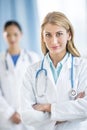 Confident Female Doctor Standing Arms Crossed In Clinic Royalty Free Stock Photo