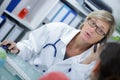 Confident female doctor talking on phone with patient Royalty Free Stock Photo