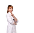 Confident female doctor in a white coat posing with a slight smile. Cropped shot isolated on white, copy space. Royalty Free Stock Photo