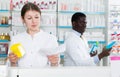 female druggist picking up prescription medicines