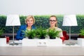 Confident Female Environmentalists Sitting At Desk Royalty Free Stock Photo