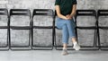 Confident female job seeker sitting in corridor of temp agency