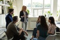 Confident female leader, coach holding briefing for multiracial team employees. Royalty Free Stock Photo