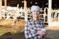 Confident female milker with milk on dairy farm Royalty Free Stock Photo