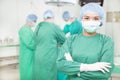 Confident female surgeons crossed hands with teams