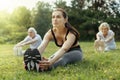 Confident female trainer stretching back during exercise Royalty Free Stock Photo