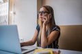 Confident female university student using smartphone during online learning