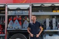 Confident firefighter stands with crossed arms, exuding resilience and preparedness, ready to respond to emergencies