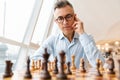 Confident focused business man playing chess Royalty Free Stock Photo