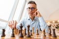 Confident focused business man playing chess Royalty Free Stock Photo