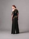 Confident ginger woman in dark silk jumpsuit. WomenÃ¢â¬â¢s clothing, fashionable gown, halter dress.