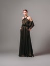 Confident ginger woman in dark silk jumpsuit. WomenÃ¢â¬â¢s clothing, fashionable gown, halter dress.