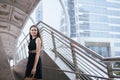 Confident girl in blackdress smling and holding shopping bags in city Royalty Free Stock Photo