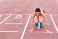 Confident girl posing in blocks to start running Royalty Free Stock Photo