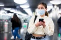 Confident girl in a protective mask entered the subway, passing through the turnstile Royalty Free Stock Photo