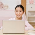 Confident girl using laptop for internet