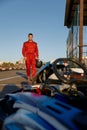 Confident go-kart driver walking to car before race at starting line Royalty Free Stock Photo