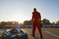 Confident go-kart driver walking to car before race at starting line Royalty Free Stock Photo