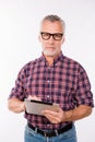 Confident gray aged man with glasses holding a tablet