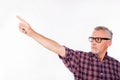 Confident gray aged man with glasses pointing away