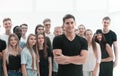Confident guy standing in front of a casual group of young people. Royalty Free Stock Photo