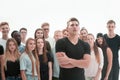 Confident guy standing in front of a casual group of young people. Royalty Free Stock Photo