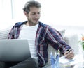 Confident guy working with laptop at home. Royalty Free Stock Photo