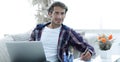 Confident guy working with laptop at home. Royalty Free Stock Photo