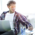 Confident guy working with laptop at home. Royalty Free Stock Photo