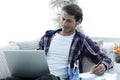 Confident guy working with laptop at home. Royalty Free Stock Photo