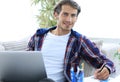 Confident guy working with laptop at home. Royalty Free Stock Photo