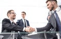 Confident handshake business partners at the Desk Royalty Free Stock Photo
