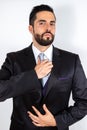 Confident handsome businessman in suit adjusting his tie, ready for success Royalty Free Stock Photo