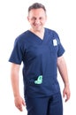 Confident and handsome doctor posing wearing blue scrubs